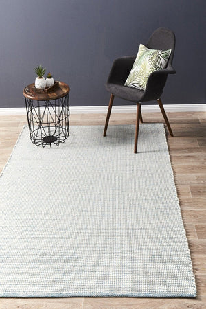Evoke Turquoise felted wool flatweave rug — lifestyle shot in coastal living room