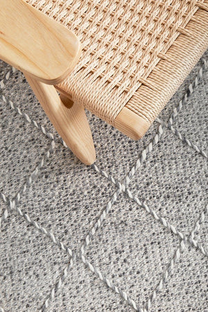 Noah flatwoven rug — grey and ivory tones in a bedroom setting