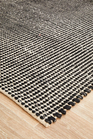 Navia Black wool rug — side angle showing double-sided flatweave construction