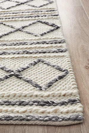 Leka Textured white grey rug styled in a minimalist Scandi bedroom