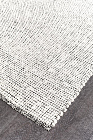 Evoke Black flatweave rug — close-up of felted wool weave detail