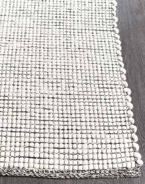 Evoke Black rug — side angle showing double-sided flatweave construction