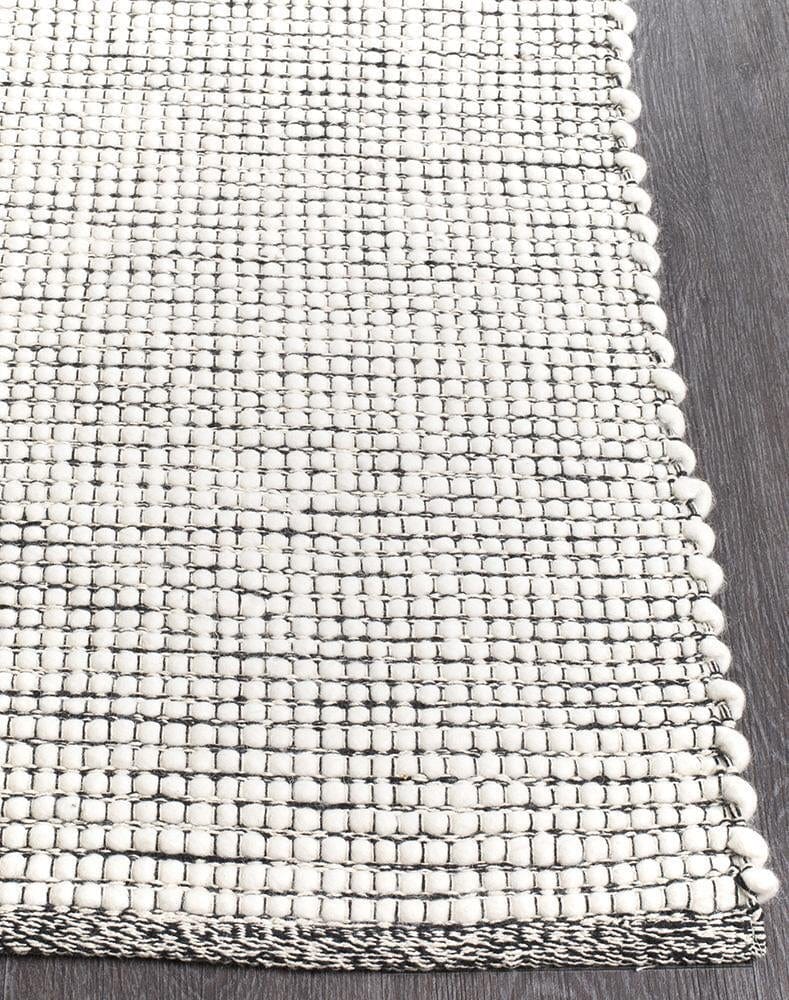 Evoke Black rug — side angle showing double-sided flatweave construction