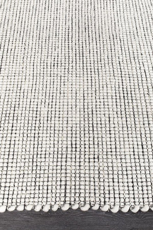 Evoke Black wool rug styled in a minimalist bedroom