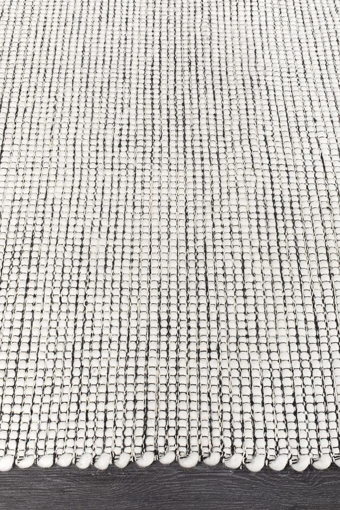 Evoke Black wool rug styled in a minimalist bedroom