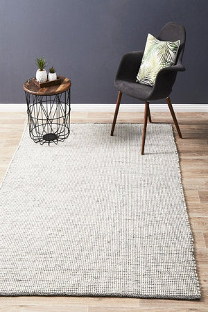 Evoke Black felted wool flatweave rug — lifestyle shot in contemporary living room