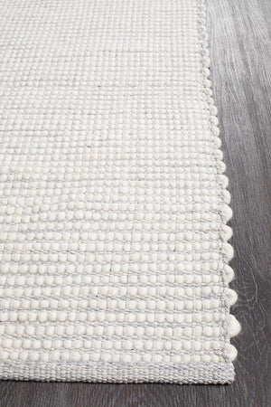 Evoke Grey wool rug styled in a Scandi-inspired bedroom