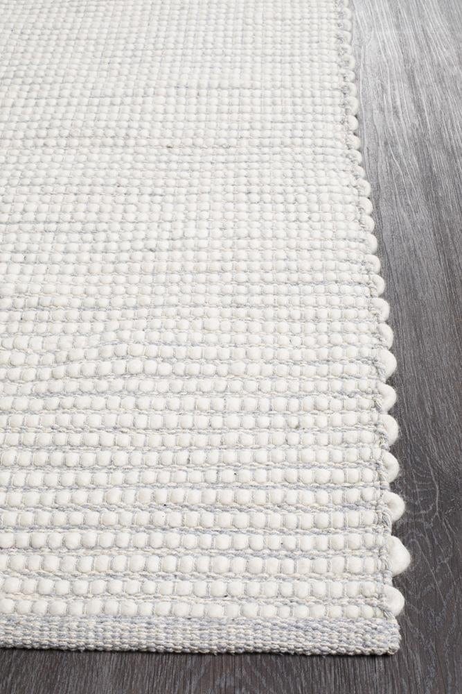 Evoke Grey wool rug styled in a Scandi-inspired bedroom