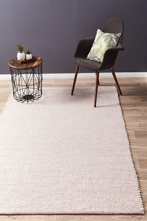 Evoke Pink felted wool flatweave rug — lifestyle shot in contemporary bedroom