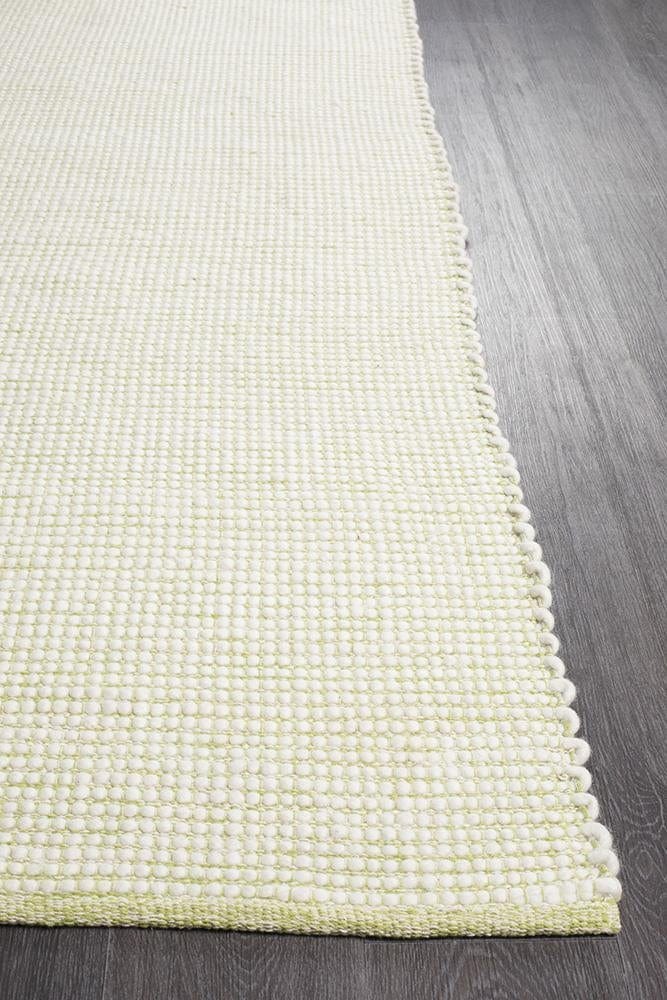 Evoke Pistachio wool rug styled in a contemporary bedroom