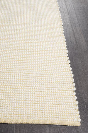 Evoke Yellow wool rug styled in a bright contemporary bedroom