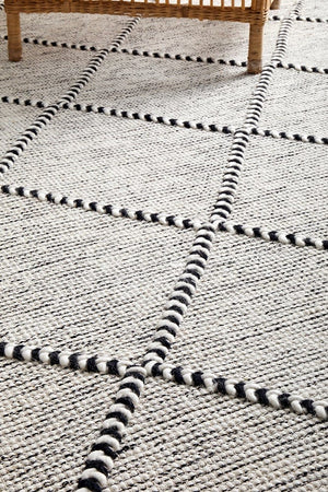 Jasmin wool rug styled in a contemporary monochrome living room