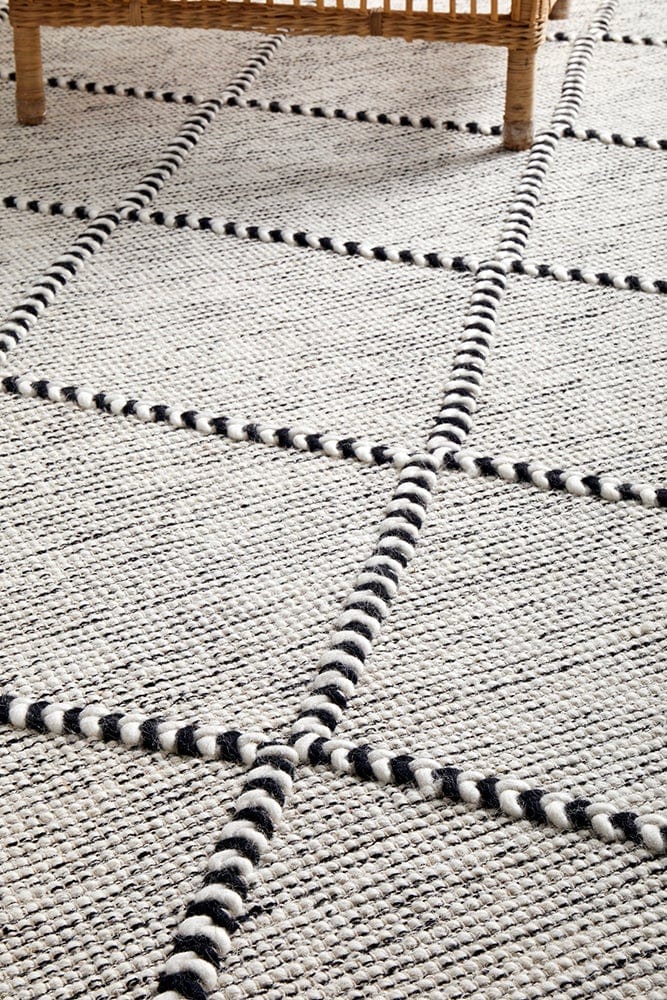 Jasmin wool rug styled in a contemporary monochrome living room