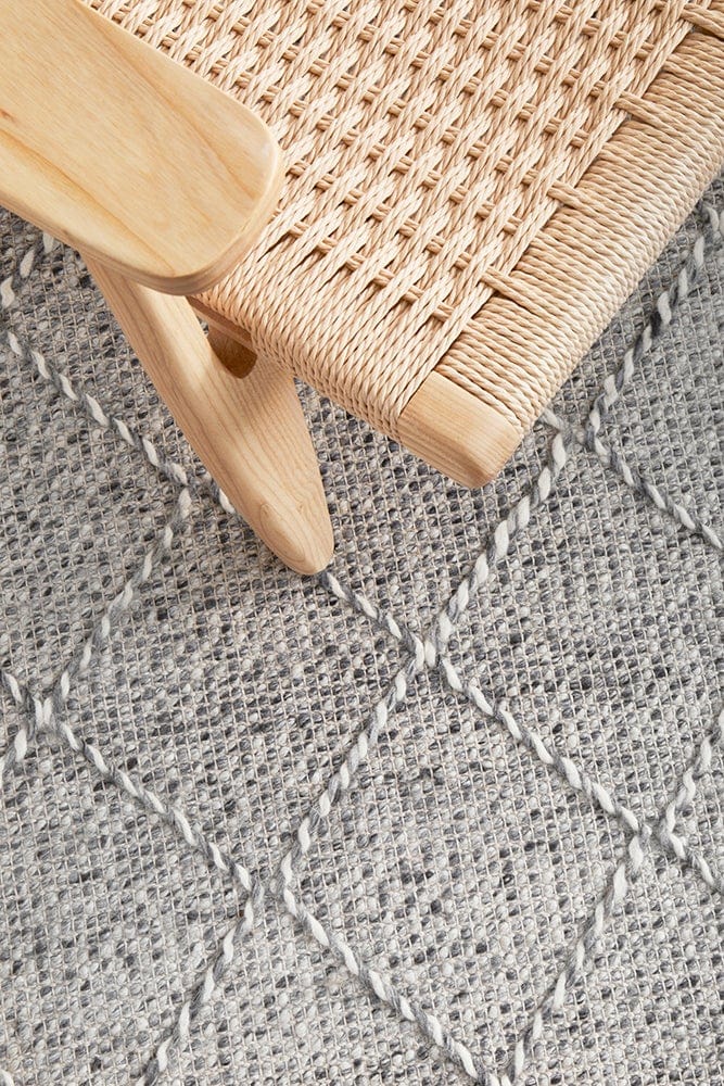 Noah flatwoven rug — grey and ivory tones in a bedroom setting