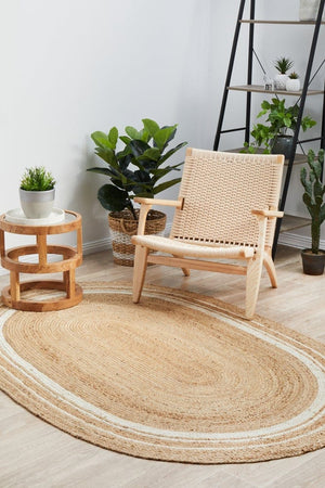 Byron 111 Natural Oval jute rug — lifestyle shot in coastal bedroom