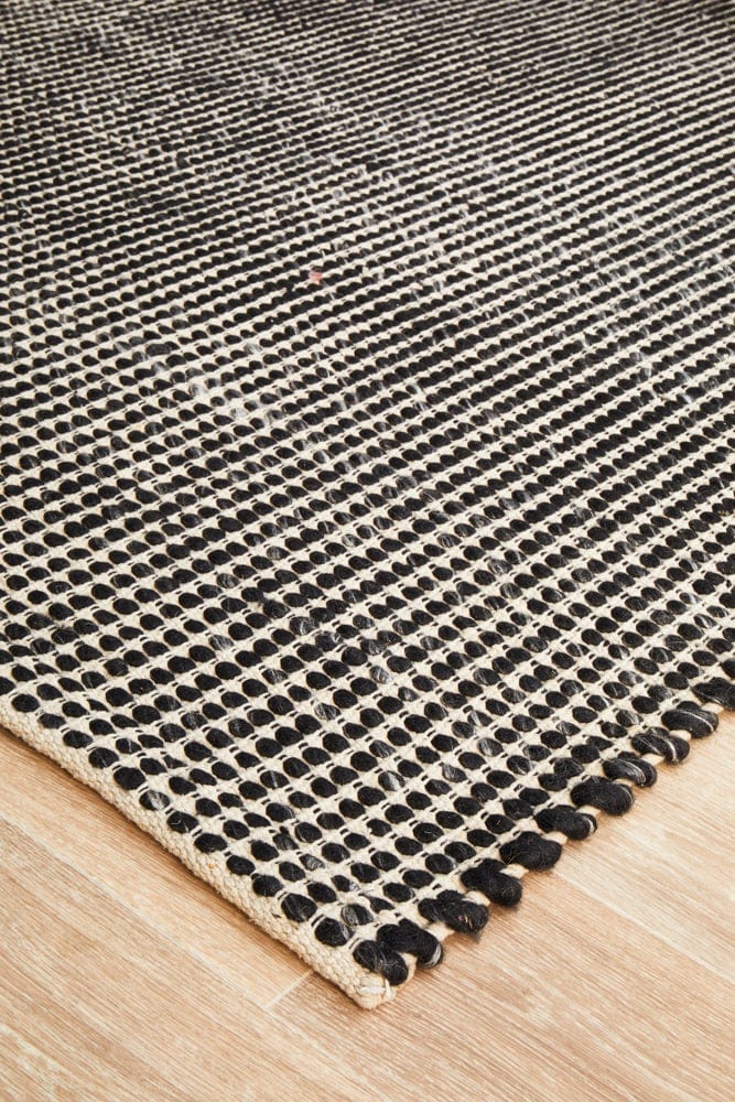 Navia Black wool rug — side angle showing double-sided flatweave construction