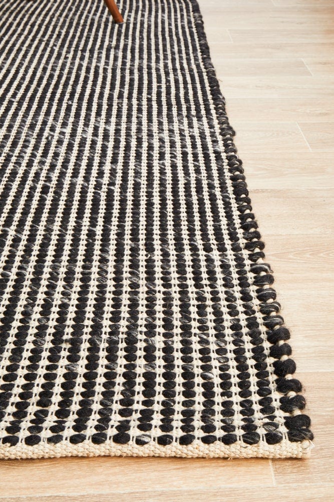 Navia Black rug — full product shot showing bold black colourway