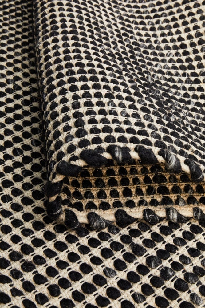 Navia Black flatweave wool rug — product shot showing full pattern