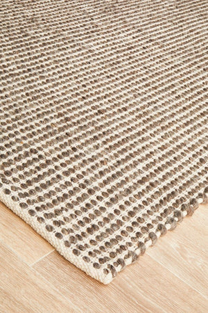 Navia brown wool rug — side angle showing double-sided flatweave construction