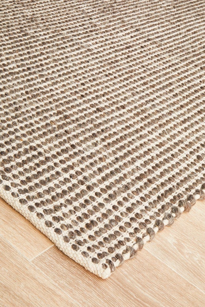 Navia brown wool rug — side angle showing double-sided flatweave construction