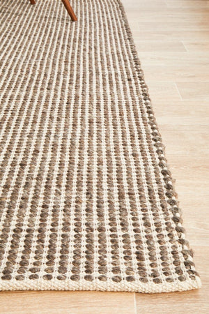 Navia brown rug — close-up of earthy brown and natural wool tones