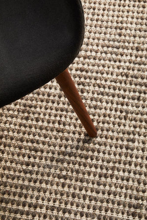 Navia brown rug — styled in a bedroom with timber flooring