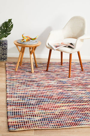 Navia Multi flatweave wool rug — lifestyle shot in bohemian living room
