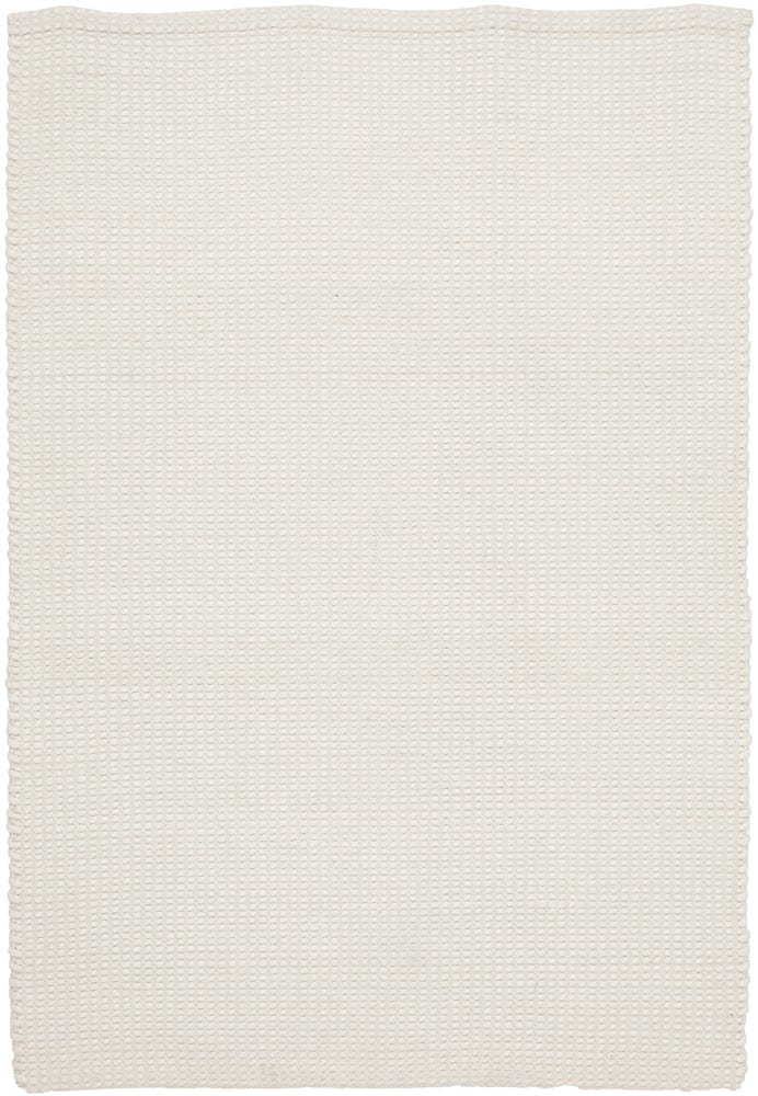 Navia White rug styled in a minimalist Scandi bedroom