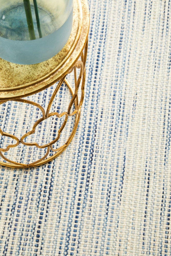 Navia Blue rug — styled in a bedroom with neutral walls
