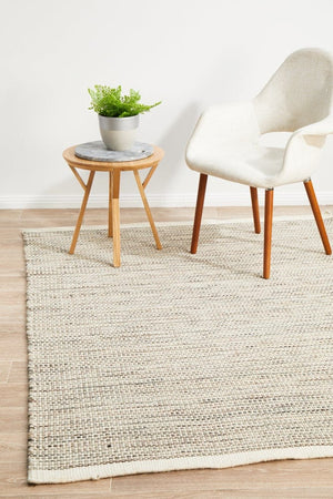 Navia Natural flatweave wool rug — lifestyle shot in coastal living room