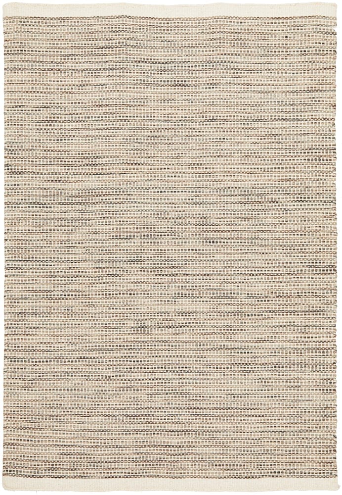Navia Natural rug styled in a minimalist living room with timber floors