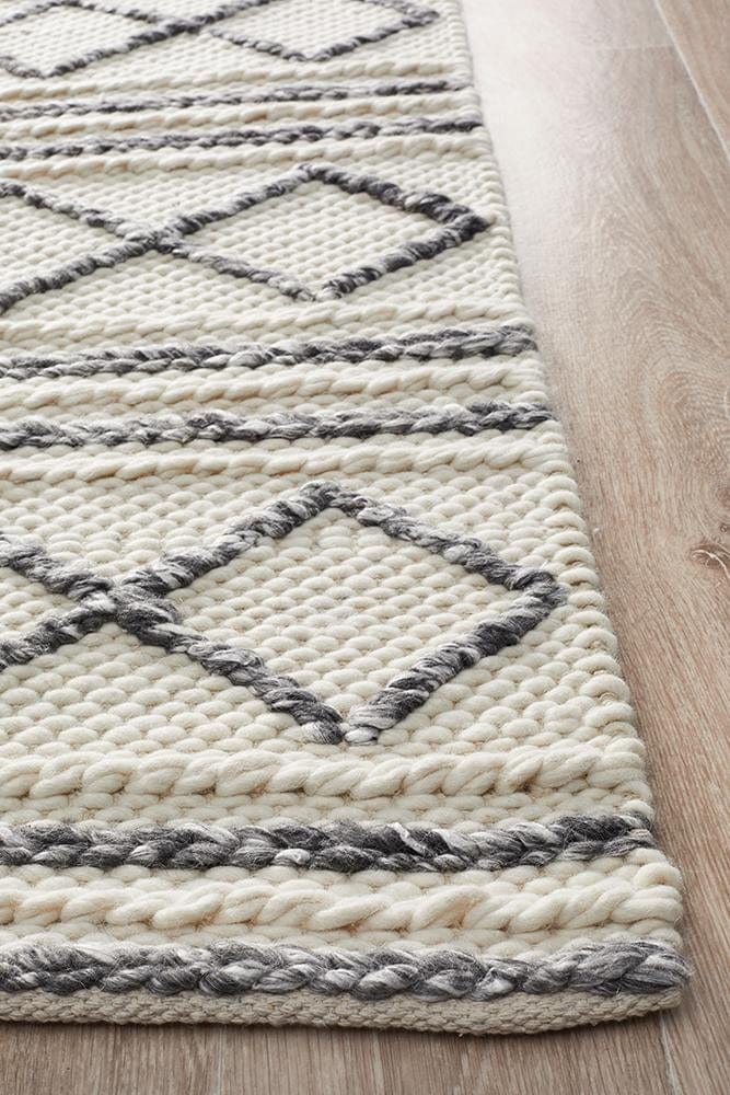 Leka Textured white grey rug styled in a minimalist Scandi bedroom